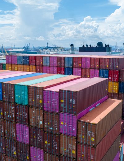 Stern of large cargo container ship import export container box on the ocean sea on blue sky back ground concept transportation logistic and service to customer and supply change